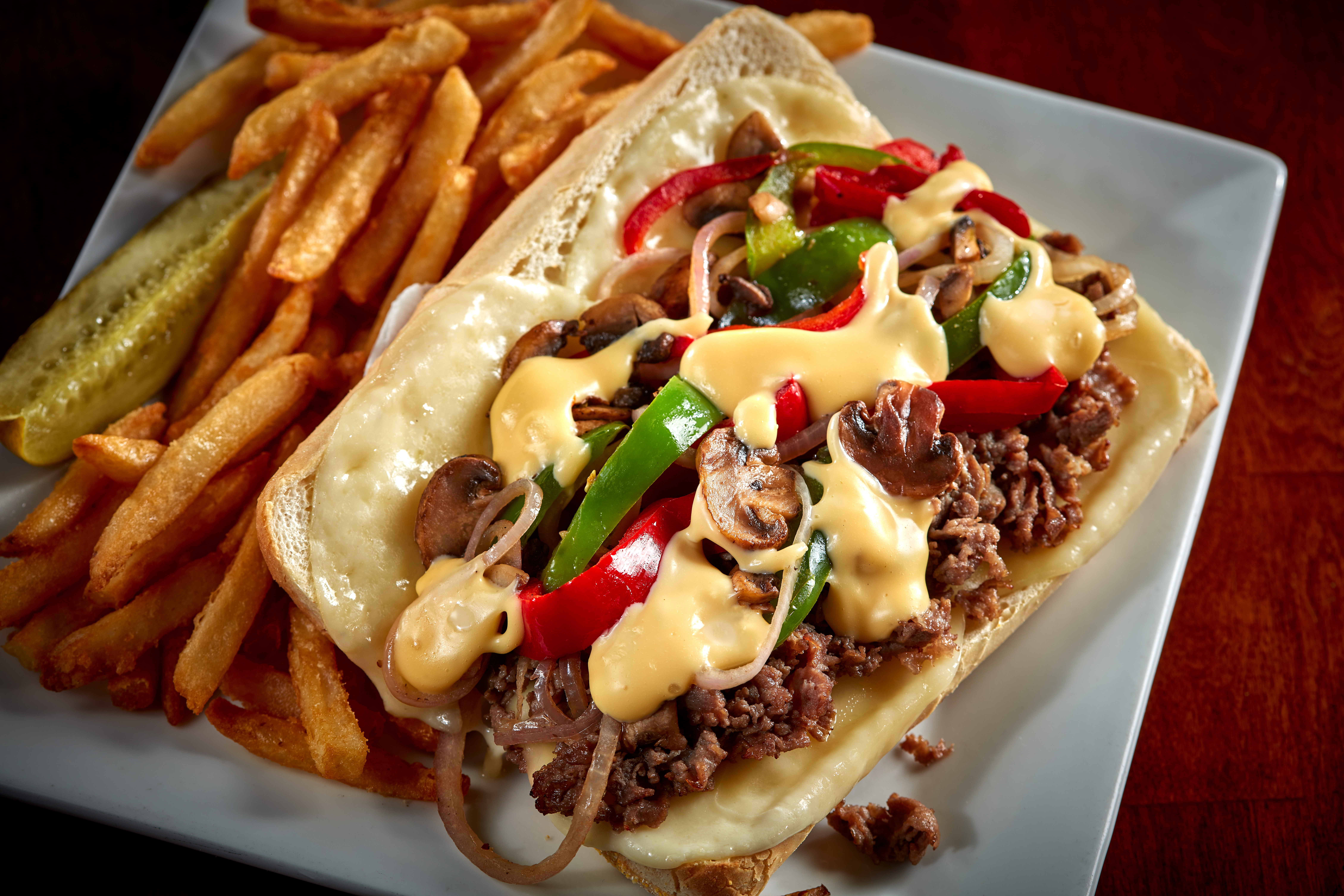 Shaved sirloin steak with sauteed red onion, mushrooms, green and red peppers topped with melted provolone cheese and our Spotted Cow beer cheese. All stuffed into a hoagie bun.  $16.99