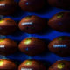 Footballs on a wall with a blue background